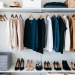 A simple, organized wardrobe with essential, mix-and-match pieces displayed neatly on hangers and shelves